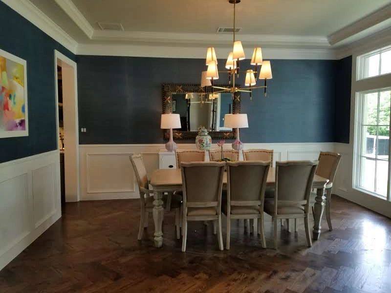 Dining room with dark painted walls and wood flooring