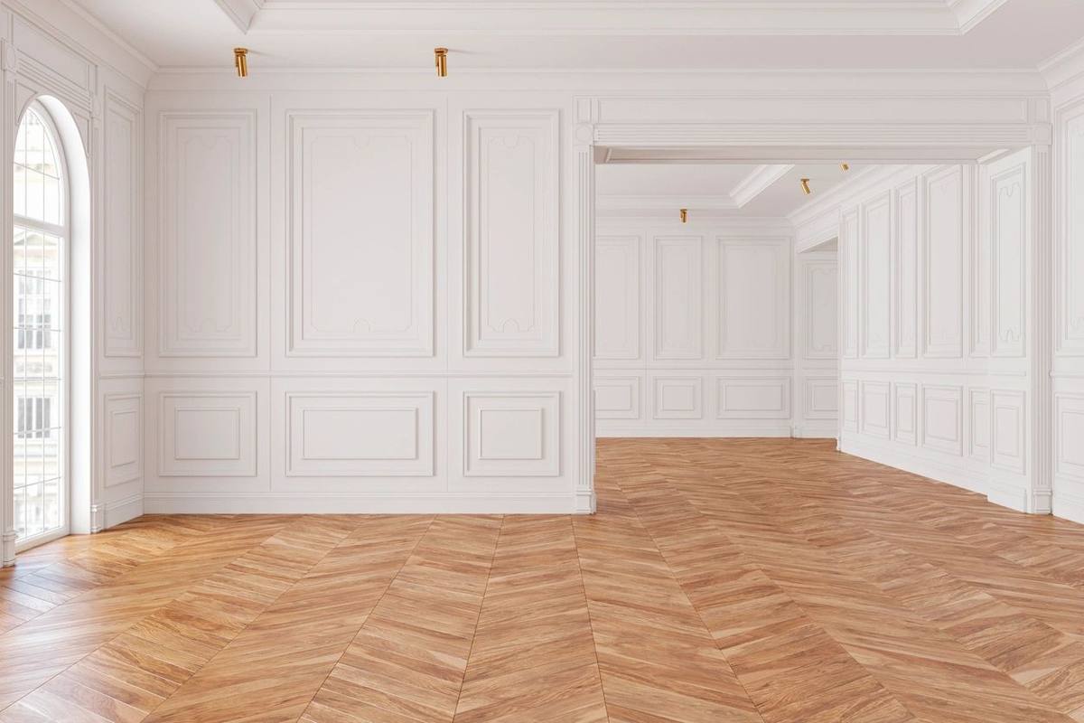Bright room with white paneled walls and herringbone floor