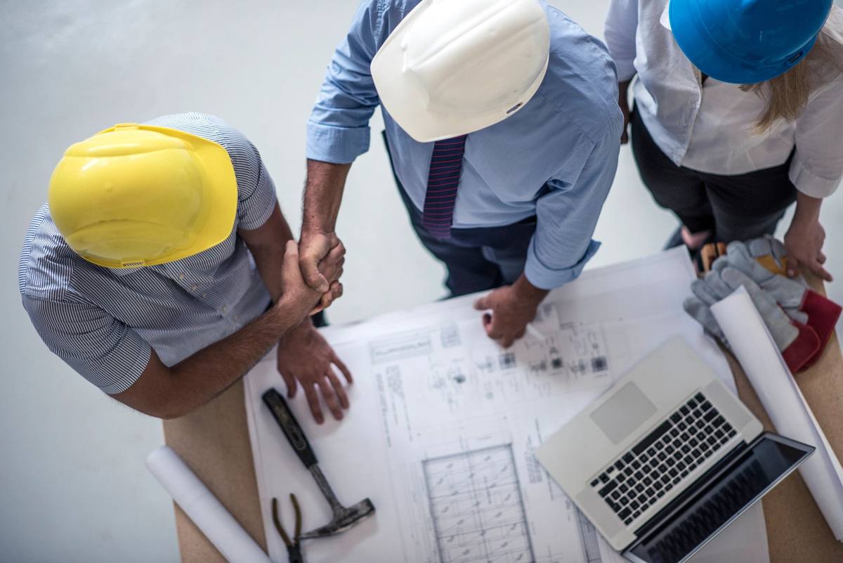 Project manager reviewing plans on site